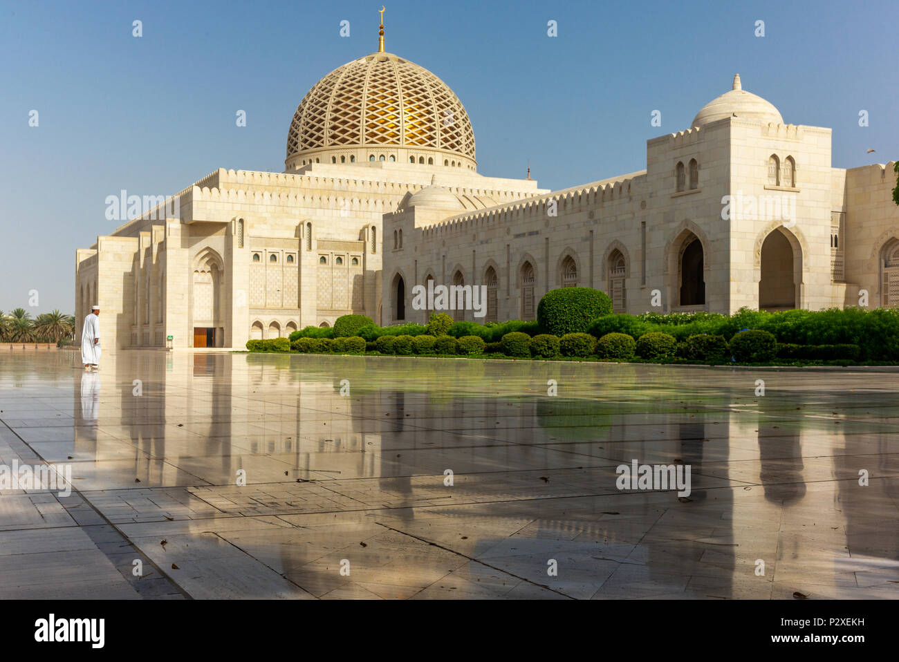 A prayer on his way to the Muscat Grand Mosque in the typical Omani