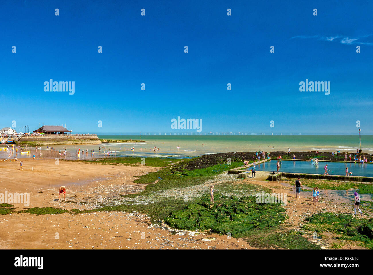 Children and families playing on beach and in lido at Viking bay, Broadstairs, kent, England Stock Photo