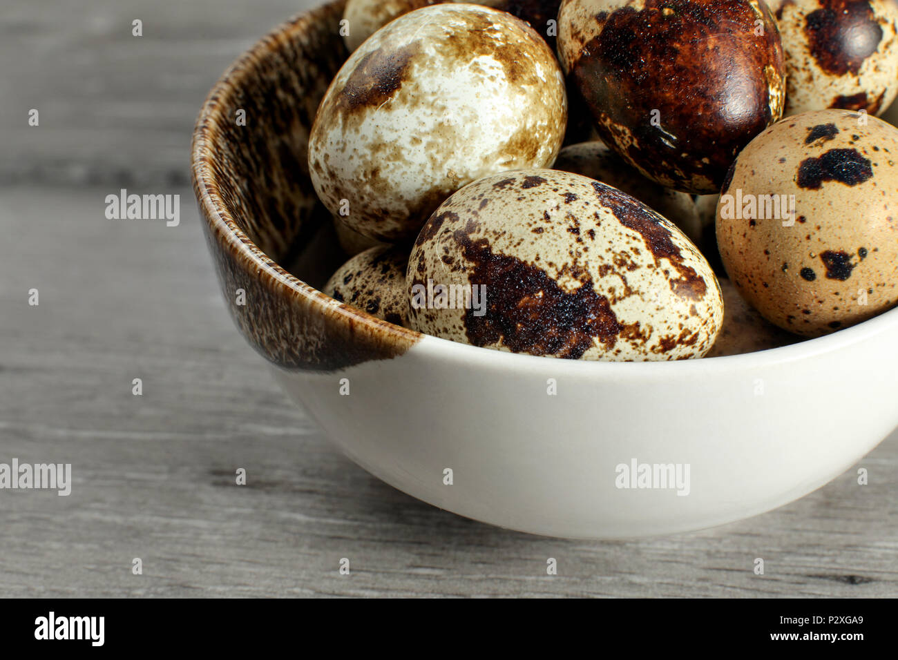 Detail on quail eggs in small bowl. Stock Photo