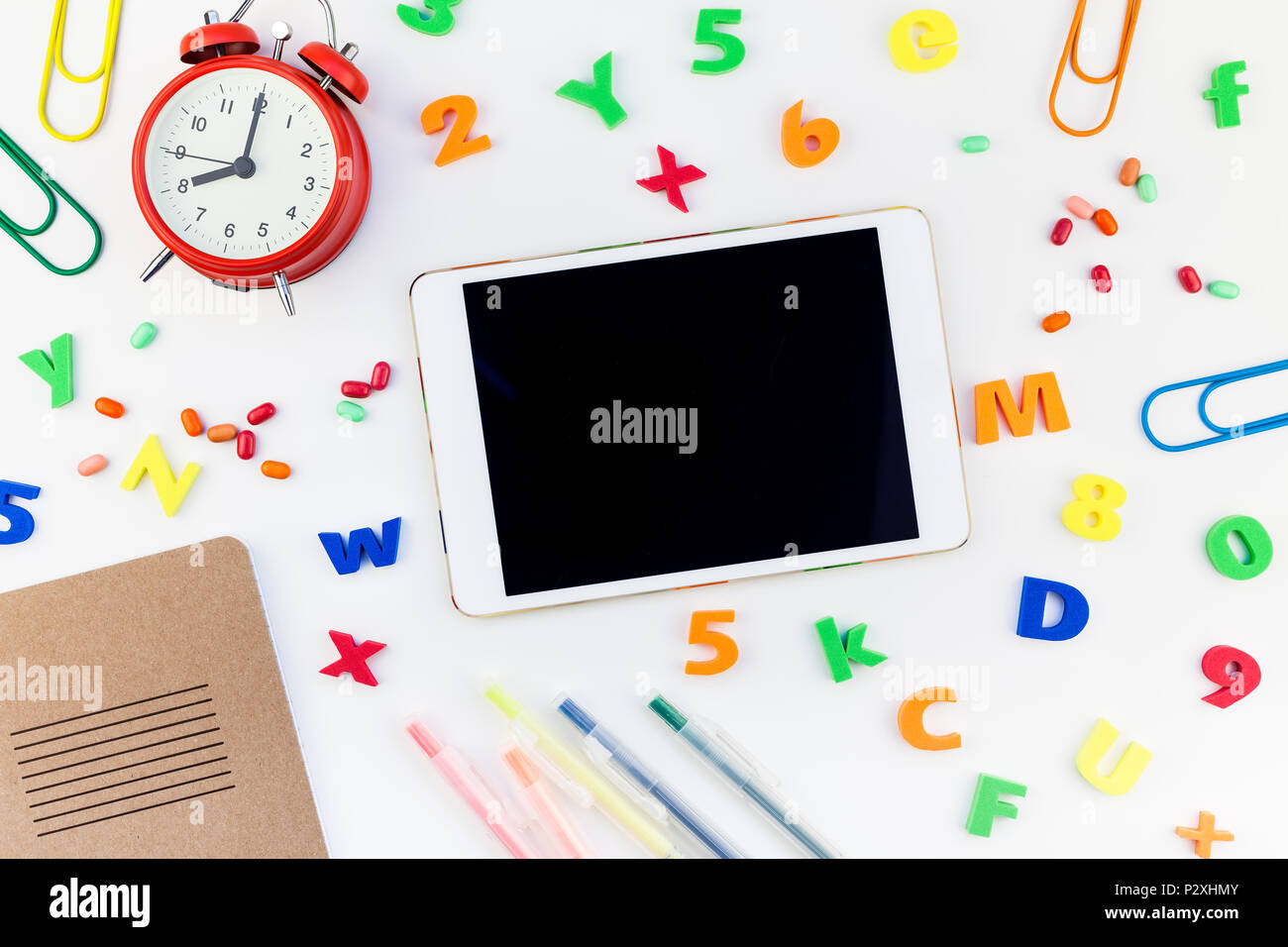 Creative flat lay back to school concept blank tablet with alarm clock ...