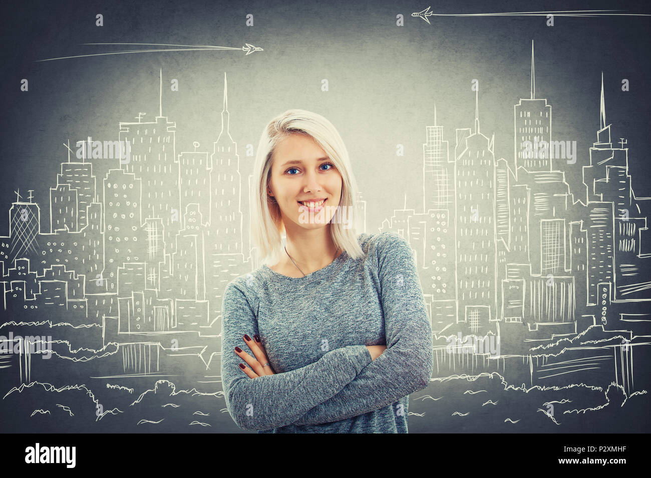 Happy smiling young woman with blue eyes and crossed hands over a urbanistic project of a big city. Megalopolis panorama, architect future planning. Stock Photo