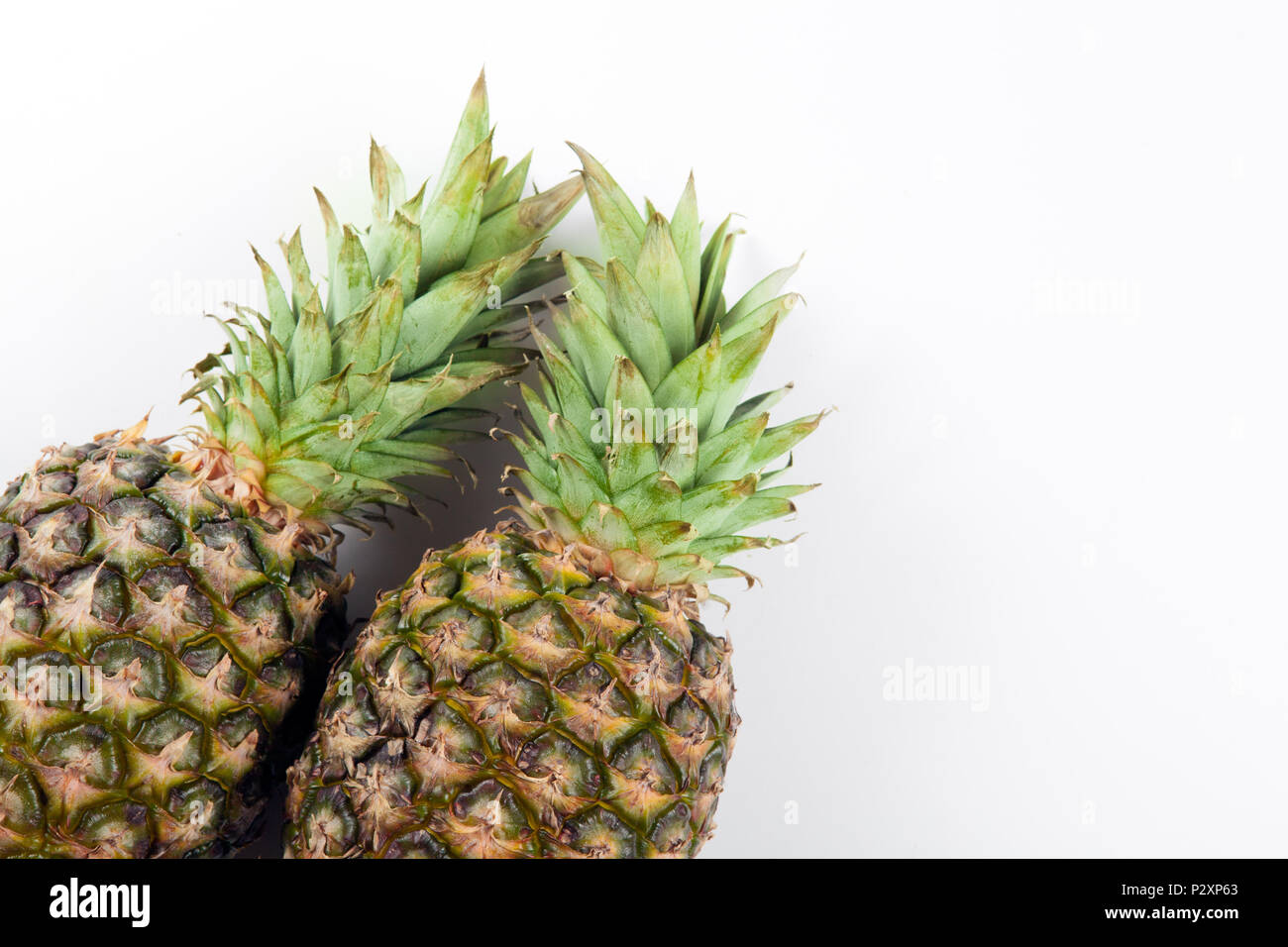 two big pineapples on a white background closeup Stock Photo