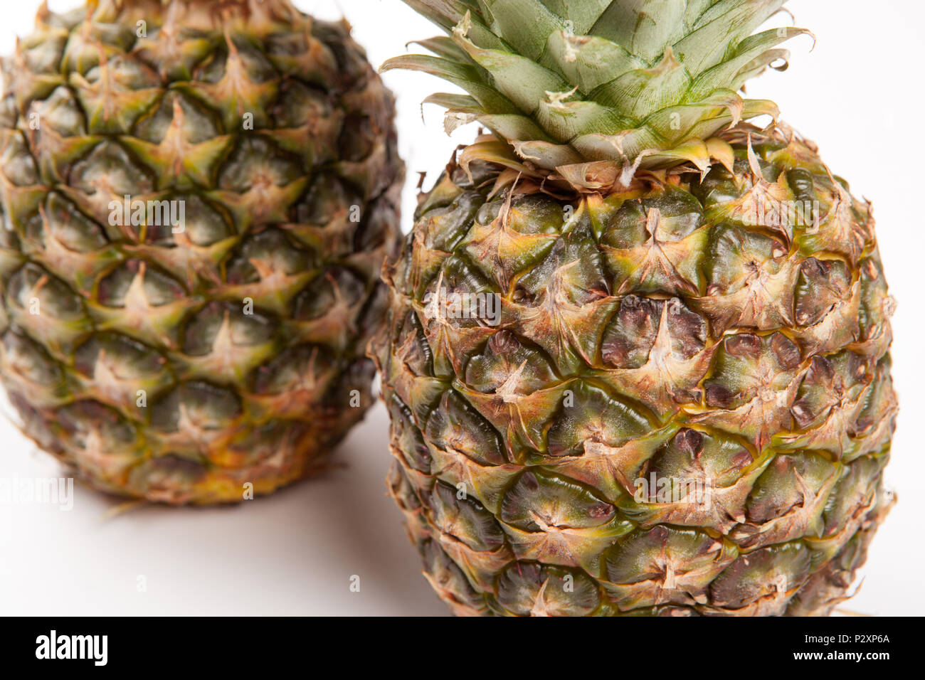two big pineapples on a white background closeup Stock Photo