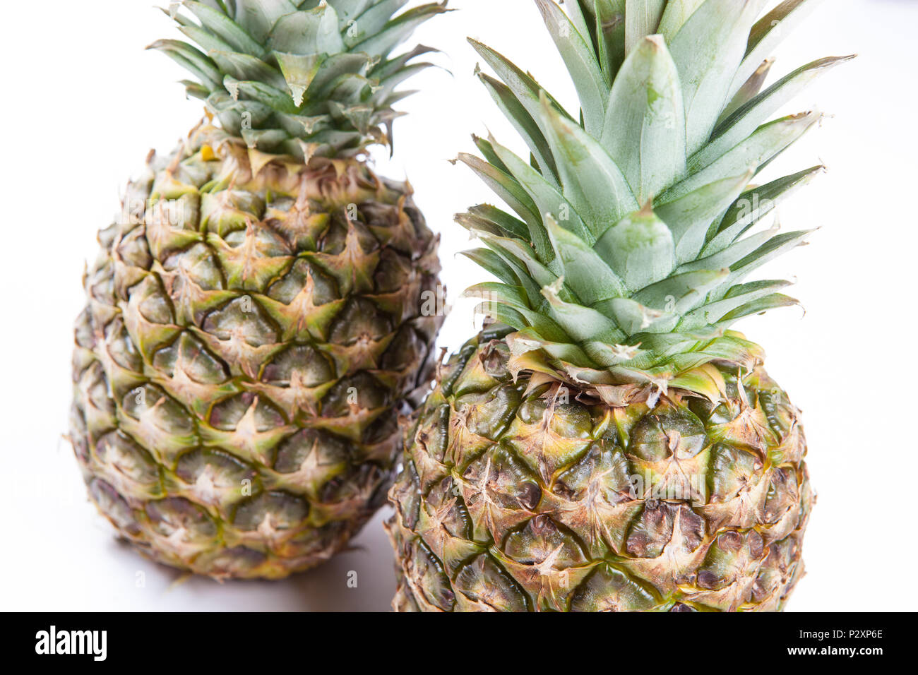 two big pineapples on a white background closeup Stock Photo