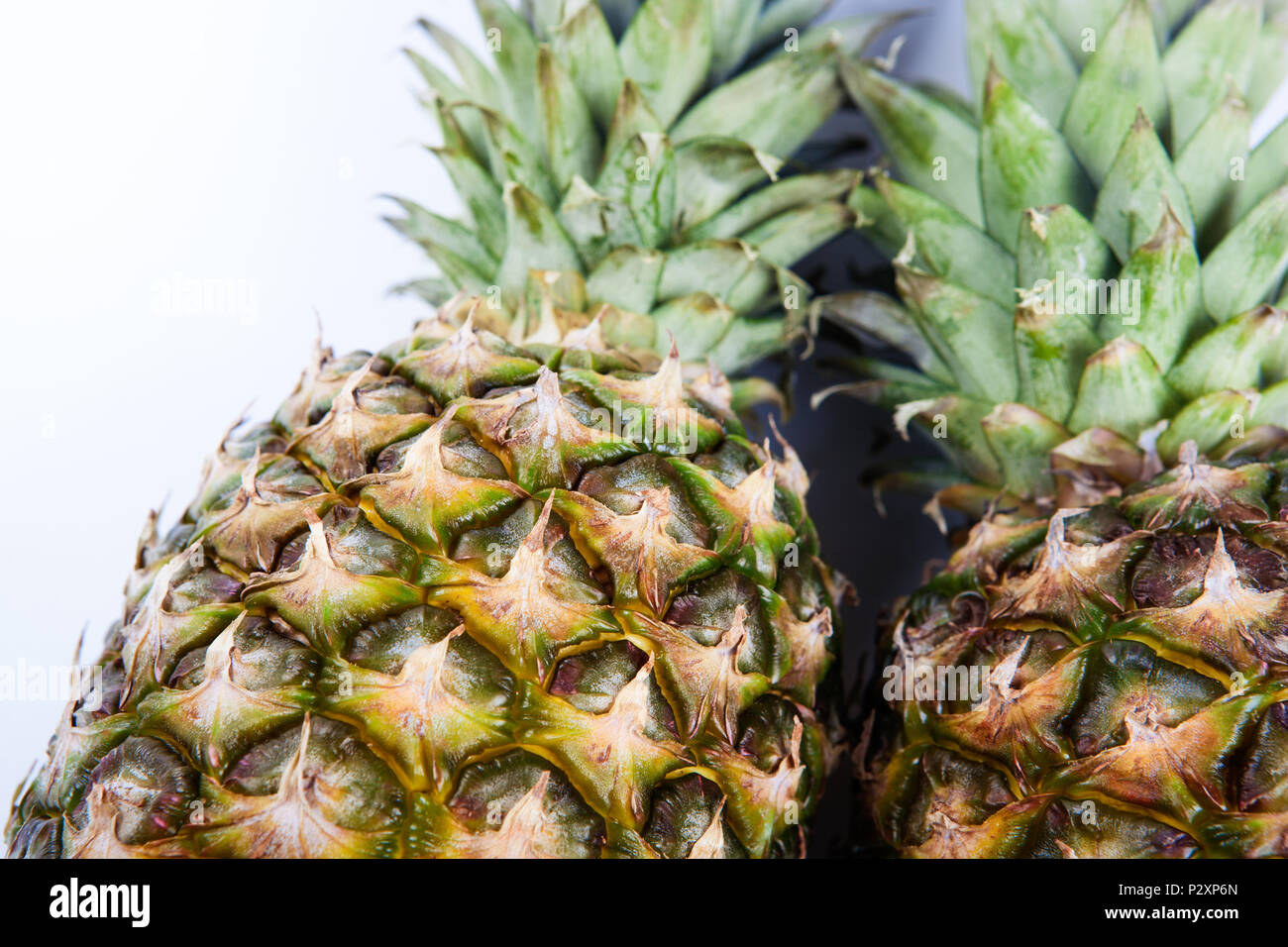 two big pineapples on a white background closeup Stock Photo