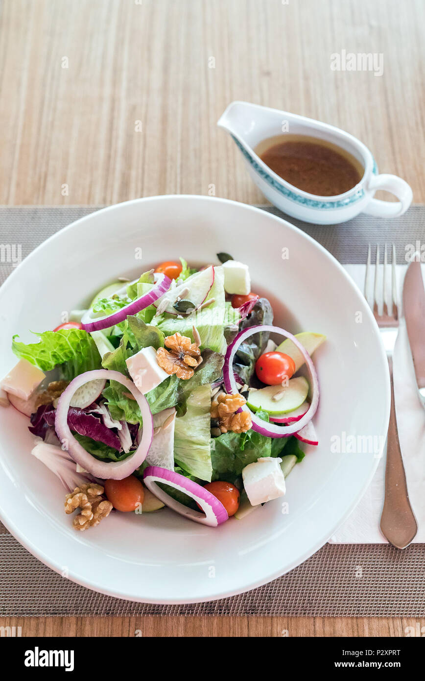 Homemade Autumn Apple Walnut Spinach Salad with Cheese and japanese sesame sauce Stock Photo