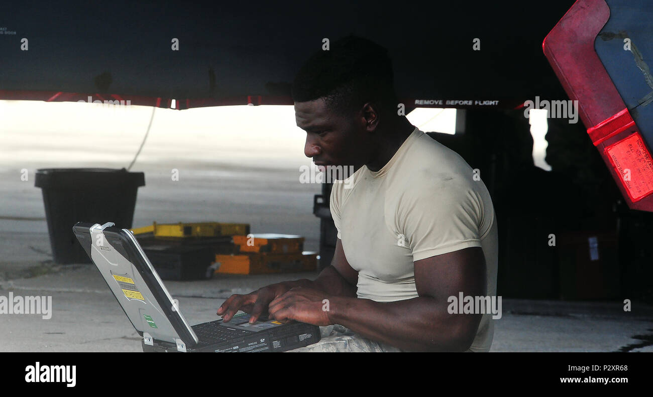 U.S. Air Force Staff Sgt. Elijah Fleming, a dedicated crew chief with the 509th Aircraft Maintenance Squadron from Whiteman Air Force Base, Mo., reviews technical orders Aug. 10, 2016 at Andersen Air Force Base, Guam.  Bomber missions strengthen capabilities by familiarizing aircrew with airbases and operations across the globe. (U.S. Air Force photo by Senior Airman Jovan Banks) Stock Photo