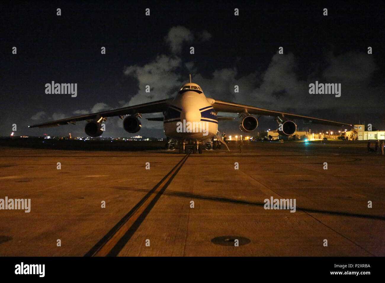 The Antonov-124 aircraft with the Volgar-Dnepr company arrives at Marine Corps Air Station Futenma, August 1, 2016. U.S. DoD members with Canadian Aviation Electronics (CAE) work in conjunction with the Volgar-Dnepr crew members to load gear for transport to Marine Corps Air Station Iwikiuni, Japan. (U.S. Marine Corps photo by Lance Cpl. Brooke Deiters/ Released) Stock Photo