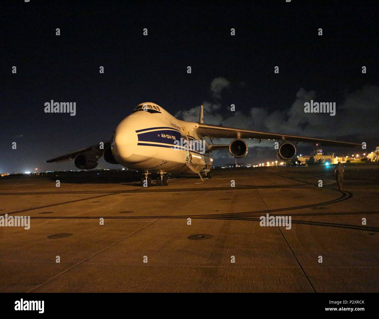 The Antonov-124 aircraft with the Volgar-Dnepr company arrives at Marine Corps Air Station Futenma, August 1, 2016. U.S. DoD members with Canadian Aviation Electronics (CAE) work in conjunction with the Volgar-Dnepr crew members to load gear for transport to Marine Corps Air Station Iwikiuni, Japan. (U.S. Marine Corps photo by Lance Cpl. Brooke Deiters/ Released) Stock Photo