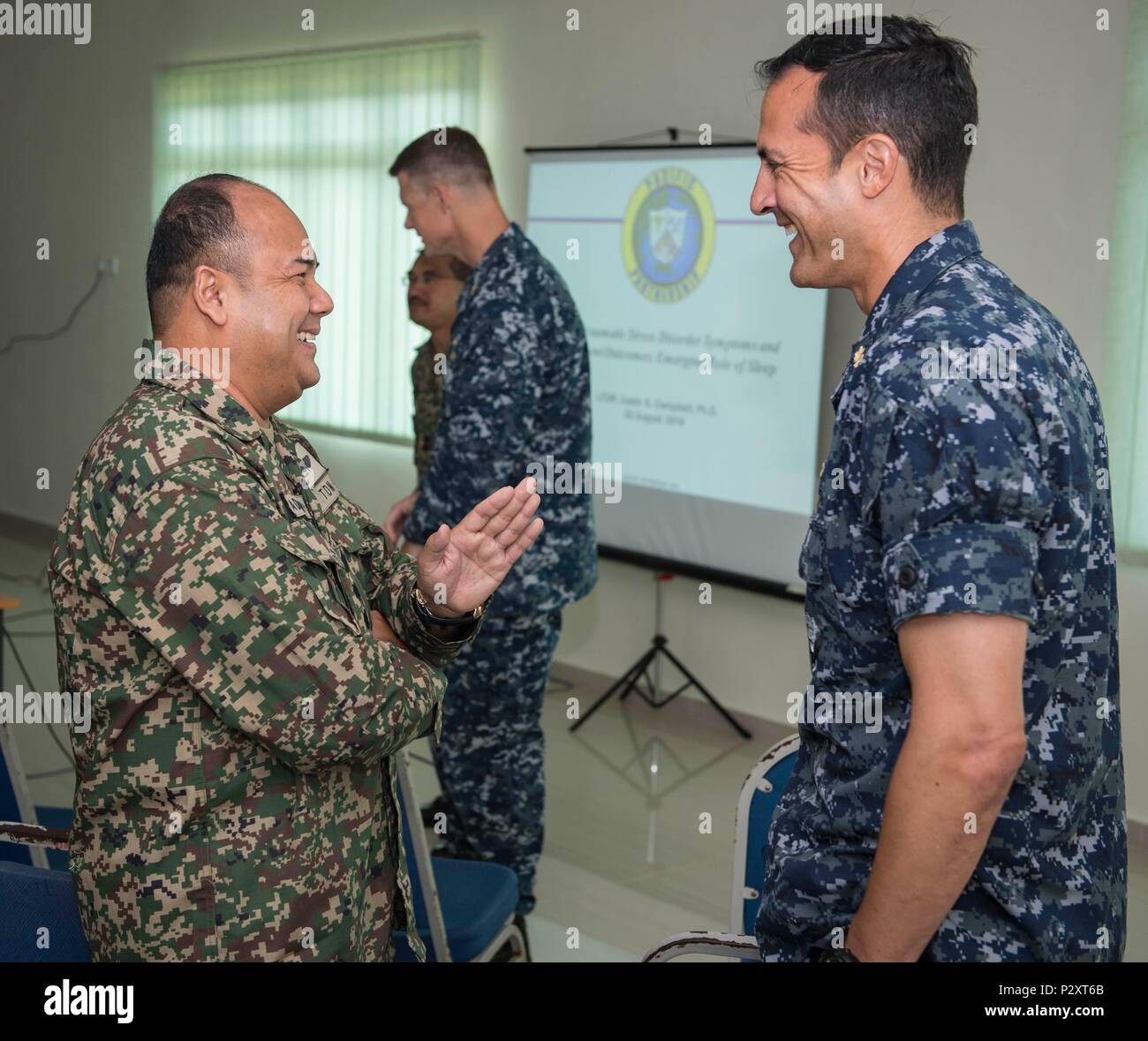 160811-N-QW941-060 KUANTAN, Malaysia (Aug. 11, 2016) Malaysian Army Col., Adnan Bin Abdullah (left), from Malacca, Malaysia, speaks with Cmdr. Fernando Leyva, from Charlotte, North Carolina and physician assigned to hospital ship USNS Mercy (T-AH 19), during a Pacific Partnership 2016 operational medicine symposium. During the symposium, Malaysian Army service members and Pacific Partnership 2016 personnel discussed mental health issues related to combat deployment, cardiology topics relative to operational platforms within diving, and Malaysian Armed Forces experiences with rapid medical resp Stock Photo