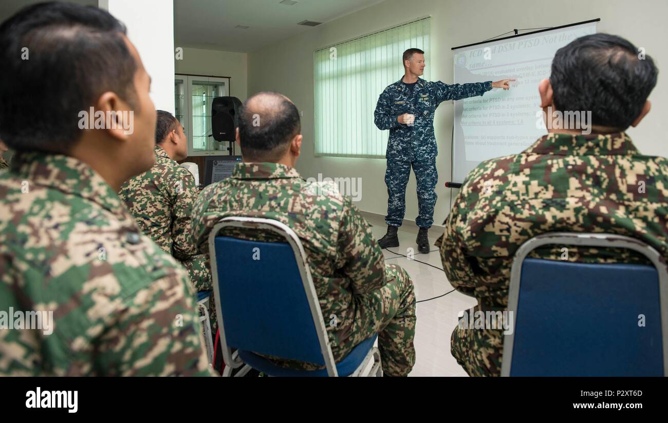 160811-N-QW941-098 KUANTAN, Malaysia (Aug. 11, 2016) Lt. Cmdr. Justin Campbell, from Thomasville, Alabama, a research psychologist assigned to hospital ship USNS Mercy (T-AH 19),  addresses participants of a Pacific Partnership 2016 operational medicine symposium. During the symposium, Malaysian Army service members and Pacific Partnership 2016 personnel discussed mental health issues related to combat deployment, cardiology topics relative to operational platforms within diving, and Malaysian Armed Forces experiences with rapid medical response. This is the first time Mercy and Pacific Partne Stock Photo
