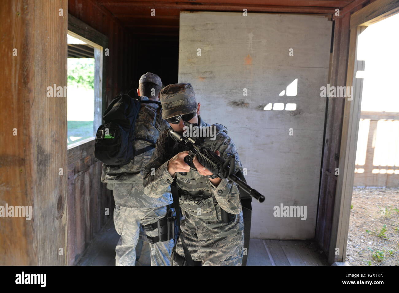 U.S. Air Force Airman 1st Class Dalton Briggs, and his partner Staff Sgt. Michael Hanes, both with the 157th Security Forces Squadron, New Hampshire Air National Guard, clear a room during skills training, Aug. 3, 2016, at the New Hampshire National Guard Training Site, Center Strafford, N.H. (Air National Photo by Airman 1st Class Ashlyn J. Correia) Stock Photo