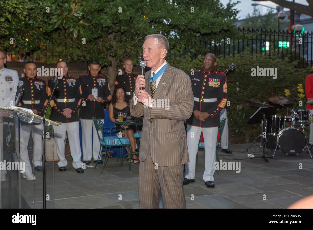 Retired U.S. Marine Corps Maj. Gen James Livingston, Medal of Honor recipient, speaks to the audience during the evening parade reception in the Marine Family Garden, Marine Barracks Washington, Washington, D.C., Aug. 5, 2016. Evening parades are held as a means of honoring senior officials, distinguished citizens and supporters of the Marine Corps. (U.S. Marine Corps photo by Cpl. Christian Varney) Stock Photo