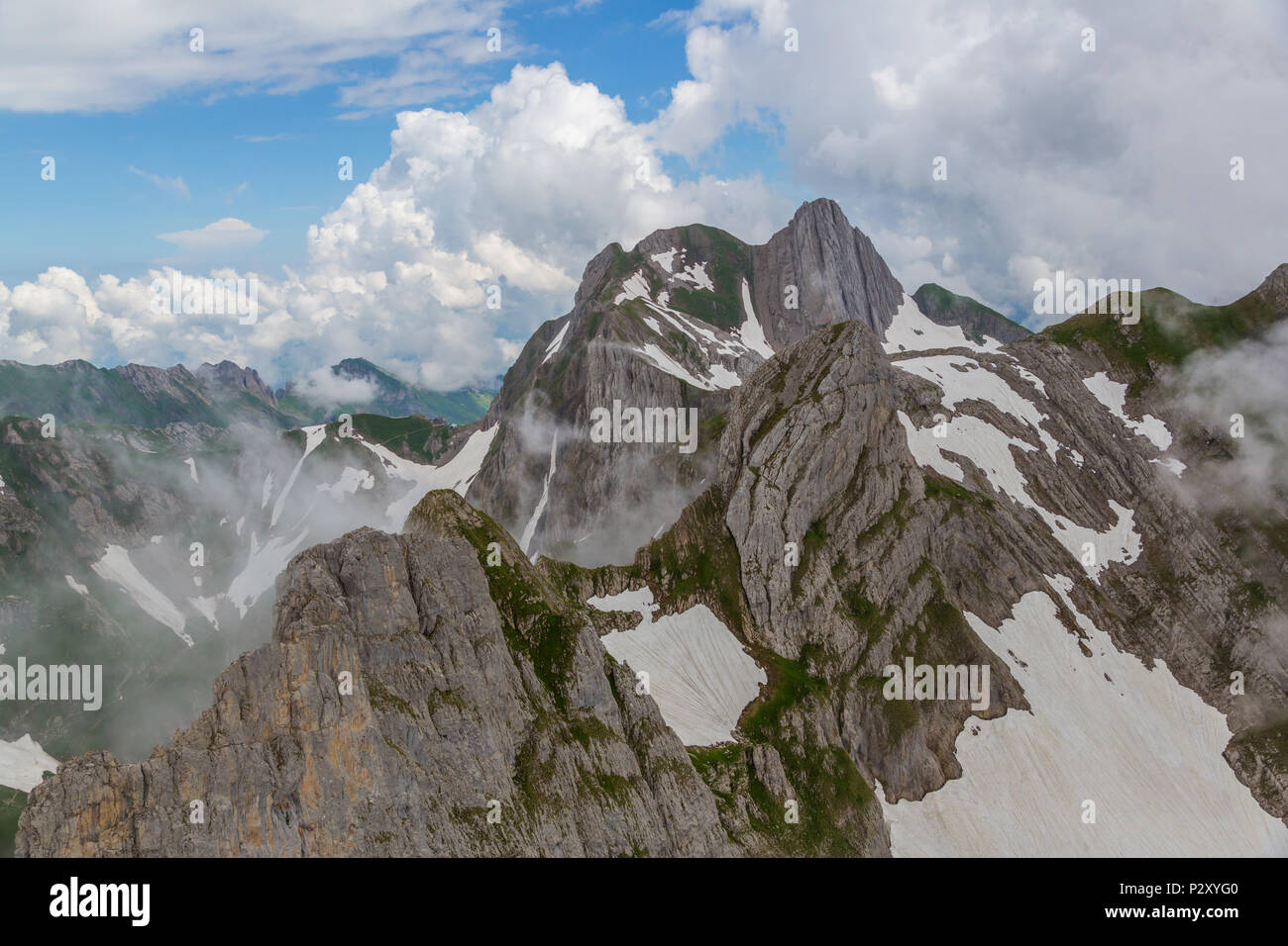 Altmann mountain in Alpstein, clouds, blue sky, snow feilds Stock Photo