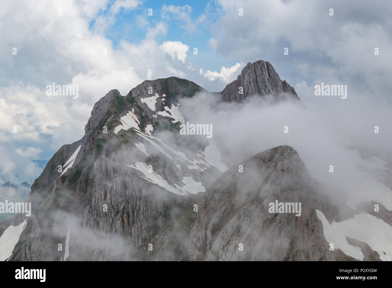 peak of natural Altmann mountain in clouds, Alpstein, clouds, blue sky Stock Photo