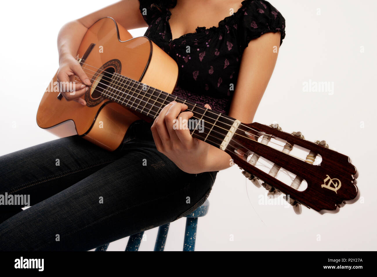 Young woman playing the acoustic guitar Stock Photo - Alamy