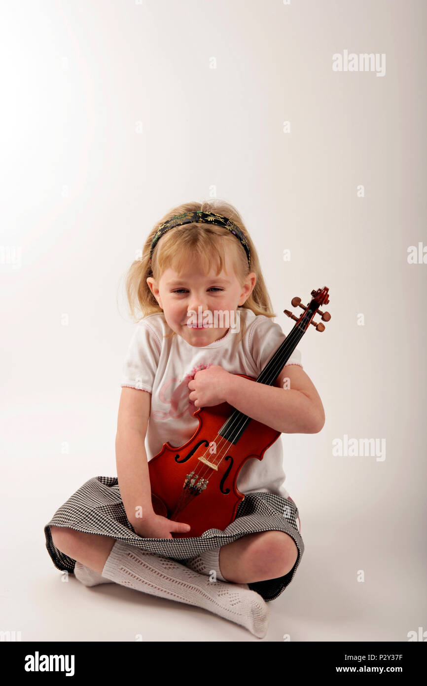 little girl holding a violin Stock Photo