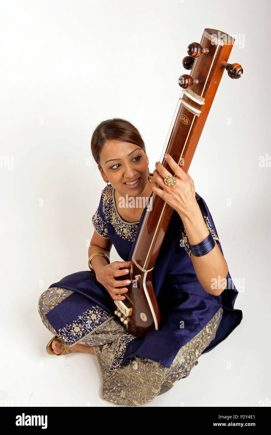 Musician playing the tanpura hi res stock photography and images