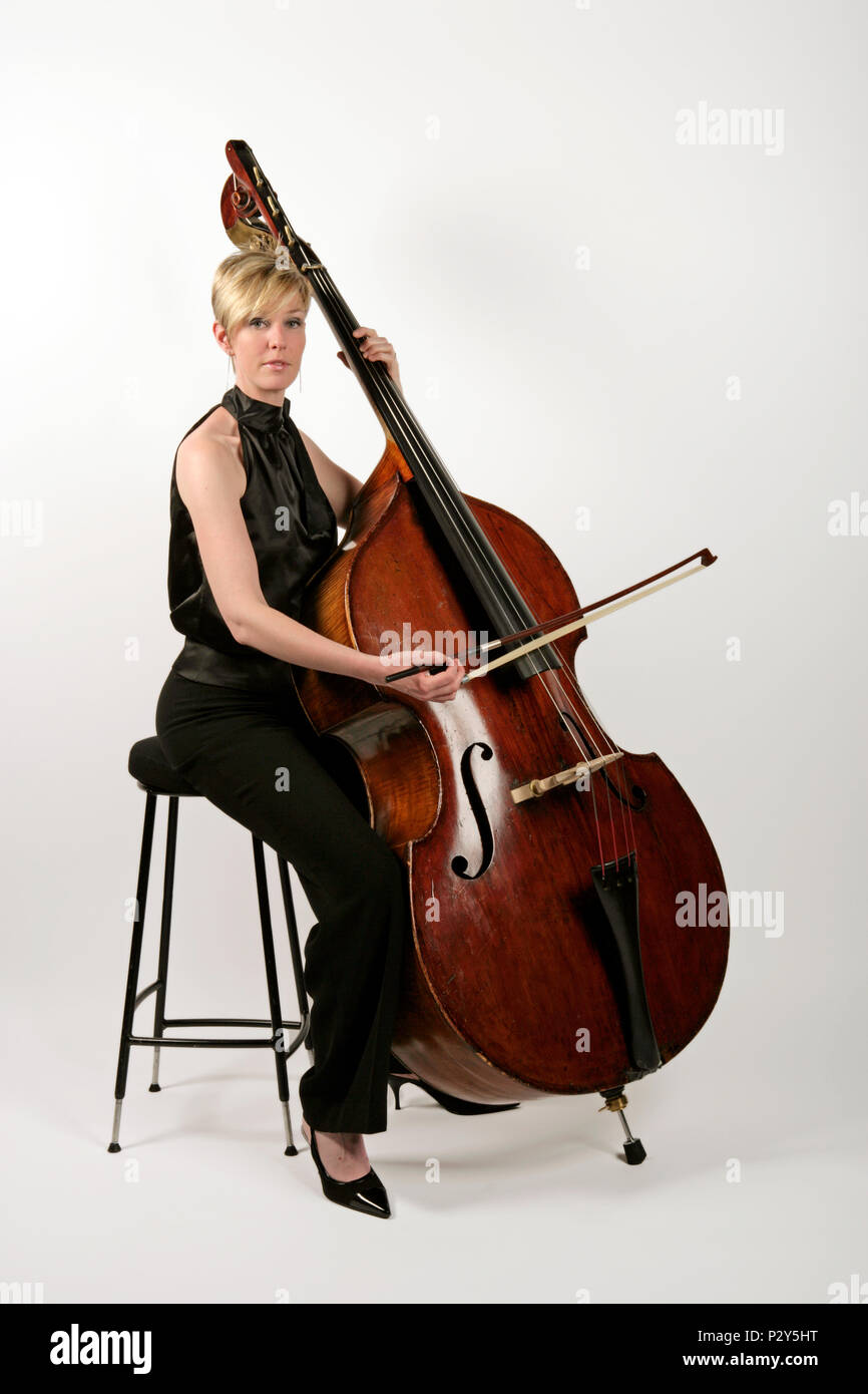 Playing Sul Tasto on a double bass. Model release Kylie Davies Stock