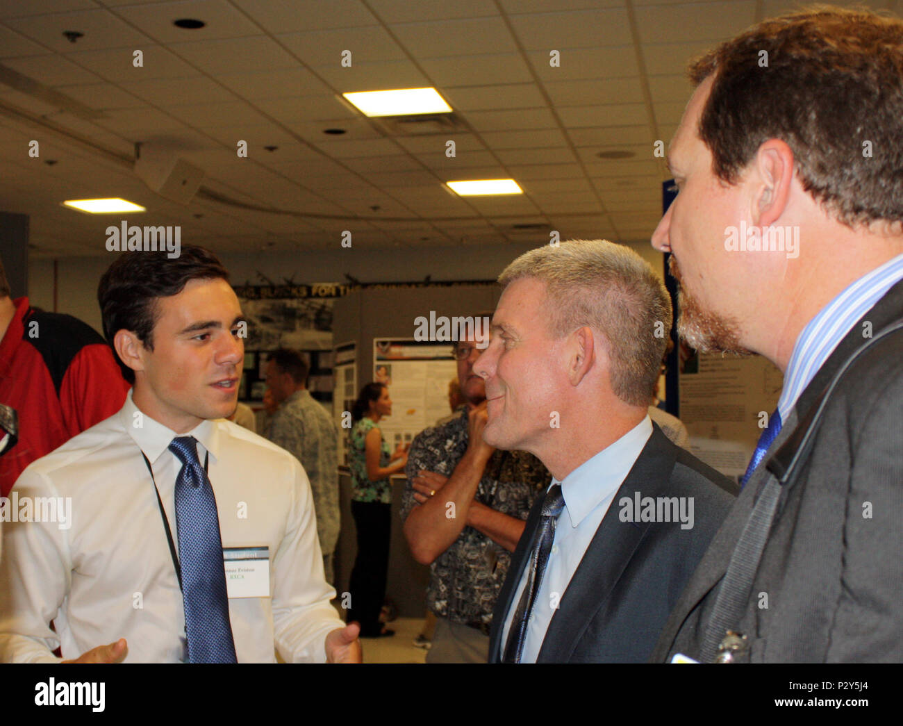 WRIGHT-PATTERSON AFB, Ohio – Thomas Lockhart (center), Director, AFRL Materials and Manufacturing Directorate, and Chad Watchorn (right), Executive Director, Regional STEM Collaborative, speak with intern Connor Eviston, an undergraduate student from the University of Cincinnati, during the 2016 RX Summer Student Poster Session, Aug. 5. Eviston researched nondestructive evaluation and thermal signals for impact-damaged polymer matrix composites this summer. Stock Photo