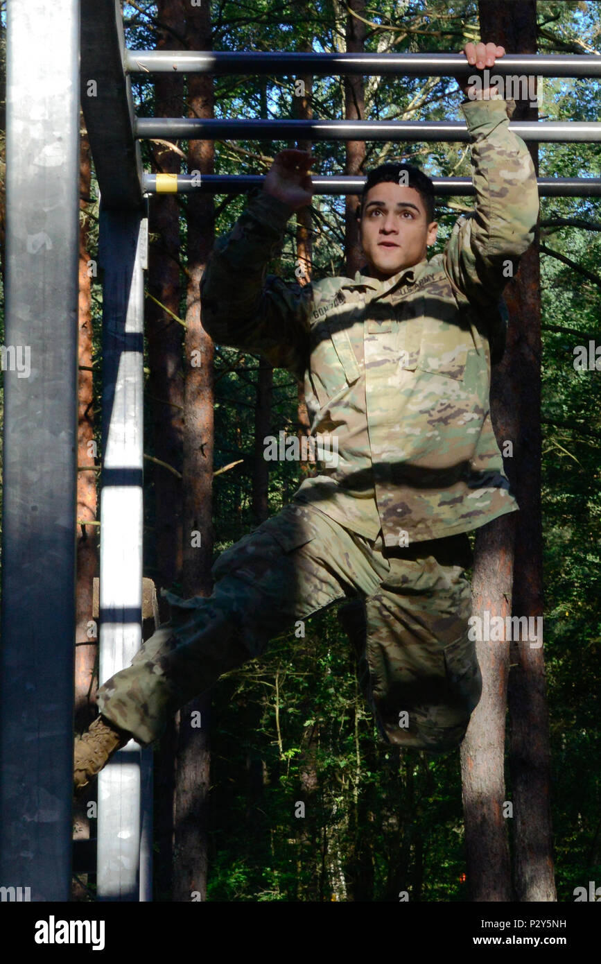 U.S. Army Spc. Gerardo Gonzalez, assigned to the 21st Theater Sustainment Command, overcomes an obstacle during the 2016 European Best Warrior Competition held at the 7th Army Training Command's Grafenwoehr Training Area, Germany, Aug. 8, 2016. The intense, grueling annual week-long competition is the most prestigious competitive event of the region. Event organizers will announce the year's top junior officer, noncommissioned officer and Soldier during a concluding ceremony scheduled for Aug. 11 at the Grafenwoehr Physical Fitness Center. (U.S. Army photo by Pfc. Emily Houdershieldt) Stock Photo