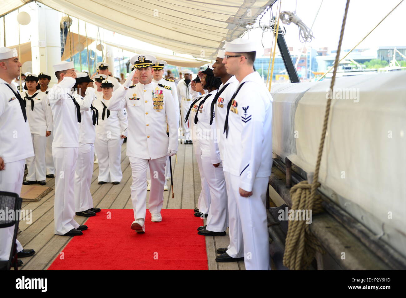 160806-N-DD899-201 BALTIMORE, Md. (Aug. 8, 2016) Cmdr.John B. Downes, center, passes through ceremonial sideboys as part of the official party for the Navy Operational Support Center (NOSC) Batimore change of command ceremony aboard USS Constellation in Baltimore Inner Harbor. Cmdr. Tasya Lacy relieved Downes as the NOSC Baltimore commanding officer. (U.S. Navy photo by Mass Communication Specialist 1st Class Sharay Bennett/Released) Stock Photo