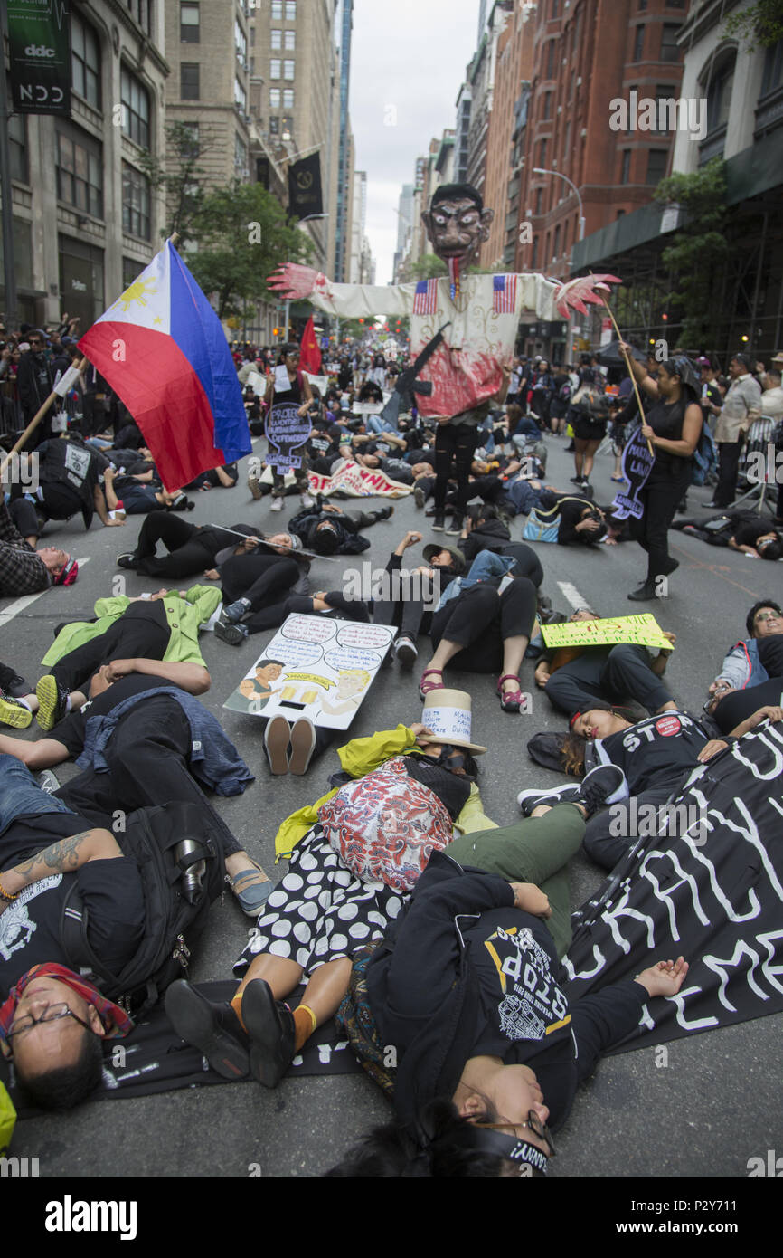 Mostly young Philippine Americans protest the dictatorial strong man tactics of President Duterte of the Phiippines and do a momentary 'Die In' in front of the VIP viewing stands at the Philippine Independence Day Parade in New York City. Stock Photo