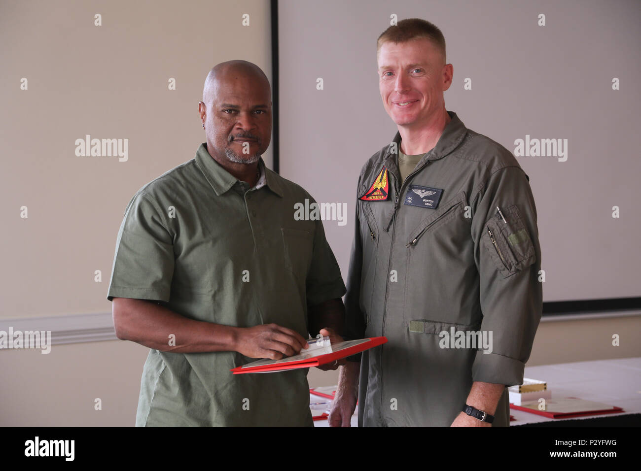 Col. Russell Burton, Marine Corps Air Station New River commanding officer,  presents Eric Clark, New River Safety Department safety specialist, with a  30 year service award during the Quarterly Civilian Breakfast at