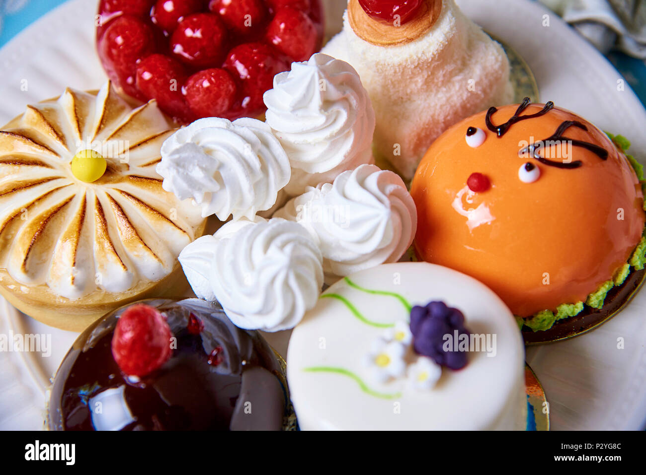 Different appetizing tasty cakes on a plate close-up. Stock Photo