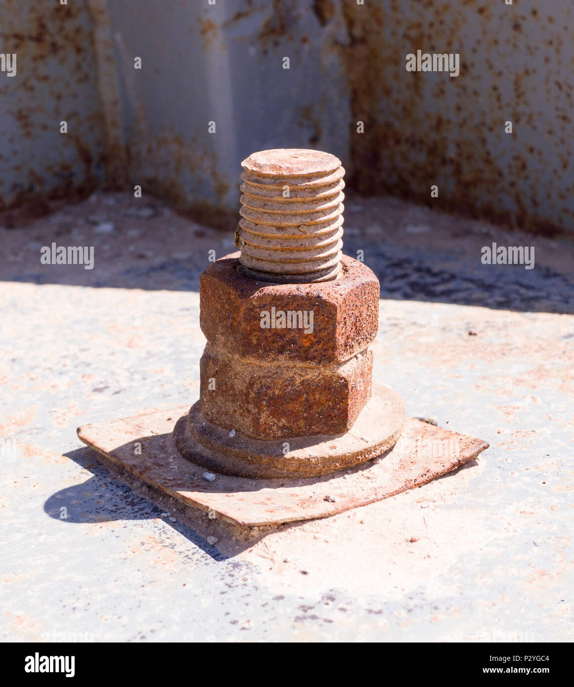 rusty iron screw with nut at sunny day. industrial concept Stock Photo