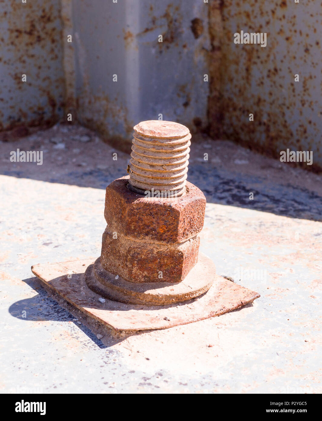rusty iron screw with nut at sunny day. industrial concept Stock Photo