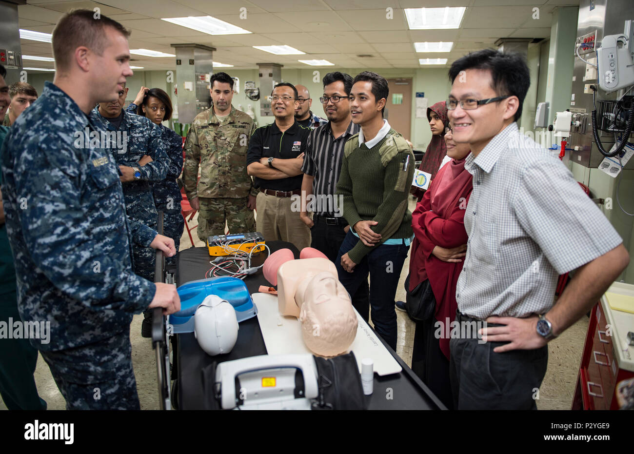 160809-N-QW941-082 KUANTAN, Malaysia (Aug. 9, 2016) Lt. Steven Whelpley (left), a native of Fredericksburg, Virginia and an emergency physician assigned to hospital ship USNS Mercy (T-AH 19), reviews defibrillator operations during a Pacific Partnership 2016 advanced cardiovascular life support training course aboard Mercy. During the training, Pacific Partnership 2016 personnel and Malaysian doctors discussed guidelines for treating patients with cardiac arrest and other life threatening emergencies. This is the first time Mercy and Pacific Partnership have visited Malaysia. During the missio Stock Photo