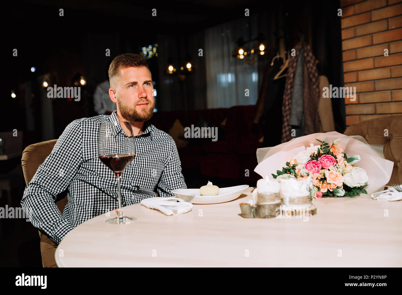 bearded man waiting for a girl on a date in a restaurant Stock Photo