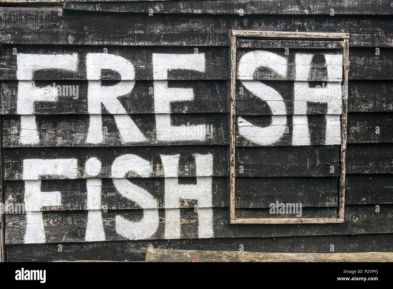 Fresh Fish painted in the Hastings Net Shops, Fisherman black wooden