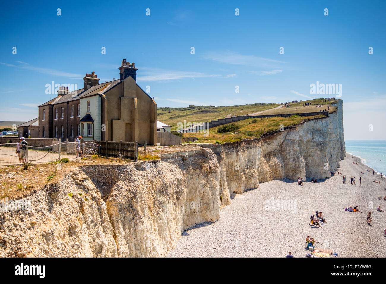 Houses near the cliff edge at Birling Gap, Seven Sisters Country Park near Eastbourne, East Sussex, UK Stock Photo