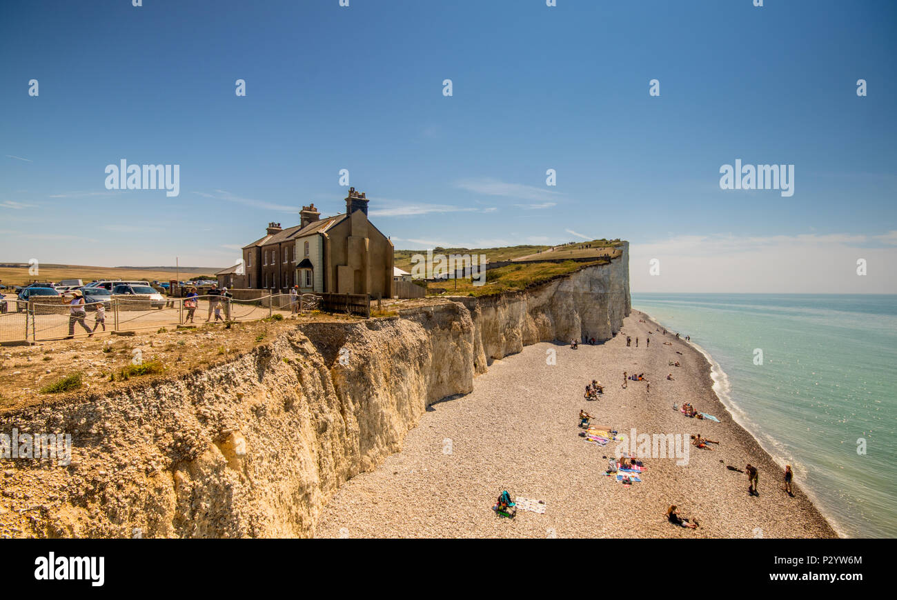 Houses near the cliff edge at Birling Gap, Seven Sisters Country Park near Eastbourne, East Sussex, UK Stock Photo