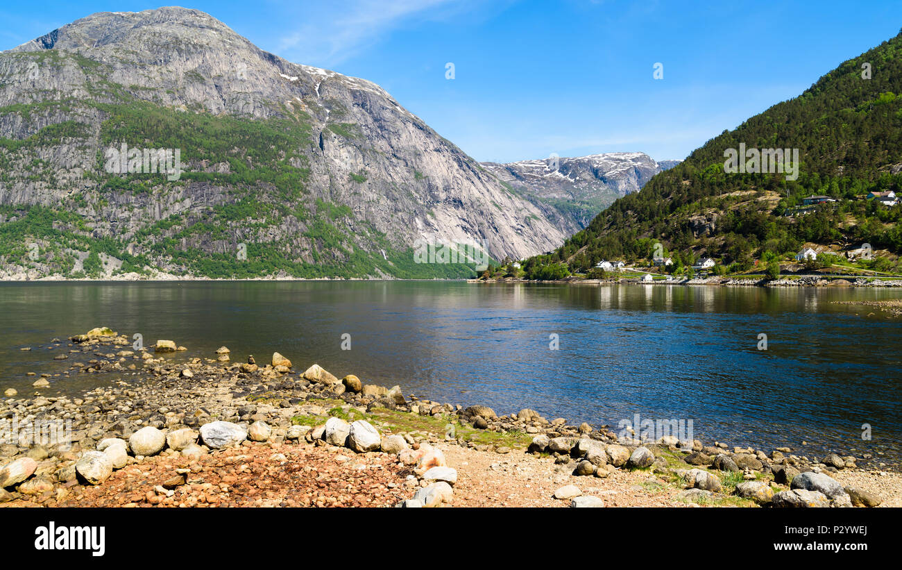 View over the fjord Eidfjorden in Hordaland, Norway, on a sunny and calm day. Stock Photo