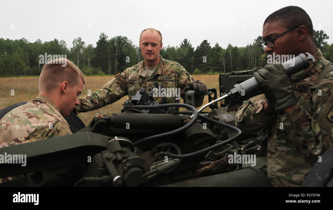 Soldiers from the 1-119th Field Artillery, Charlie Battery out of Albion, Michigan, conduct routine maintenance on the M 777 155mm Howitzer prior to artillery training for Exercise Northern Strike at Camp Grayling Joint Maneuver Training Center Aug. 12, 2016. Stock Photo