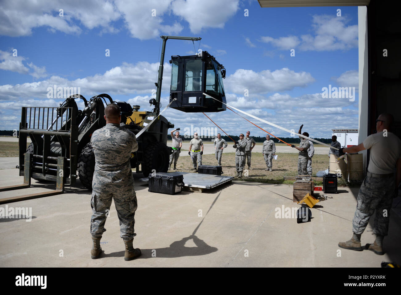 Airmen assigned to the 821st Contingency Response Group at Travis Air Force Base, California, work together to install a cab on a 10K all-terrain forklift Aug. 7, 2016, at Grayling Army Airfield, Michigan, during Exercise Northern Strike. Exercise Northern Strike is a two-week long exercise combining air and ground capabilities of multiple branches, states and countries. (U.S. Air Force photo by Senior Airman Amber Carter) Stock Photo