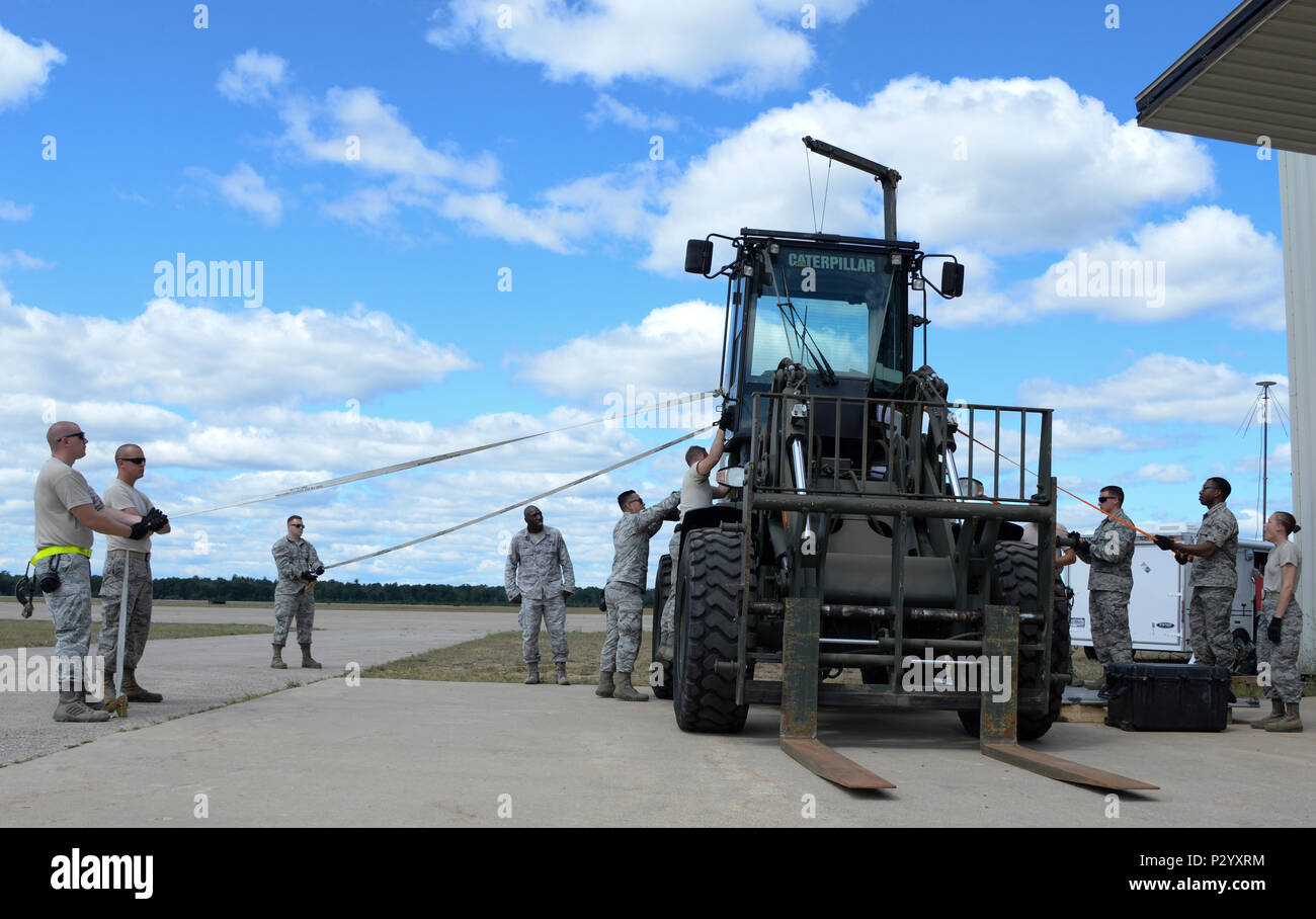 Airmen assigned to the 821st Contingency Response Group at Travis Air Force Base, California, work together to install a cab on a 10K all-terrain forklift Aug. 7, 2016, at Grayling Army Airfield, Michigan, during Exercise Northern Strike. Exercise Northern Strike is a two-week exercise long combining air and ground capabilities of multiple branches, states and countries. (U.S. Air Force photo by Senior Airman Amber Carter) Stock Photo