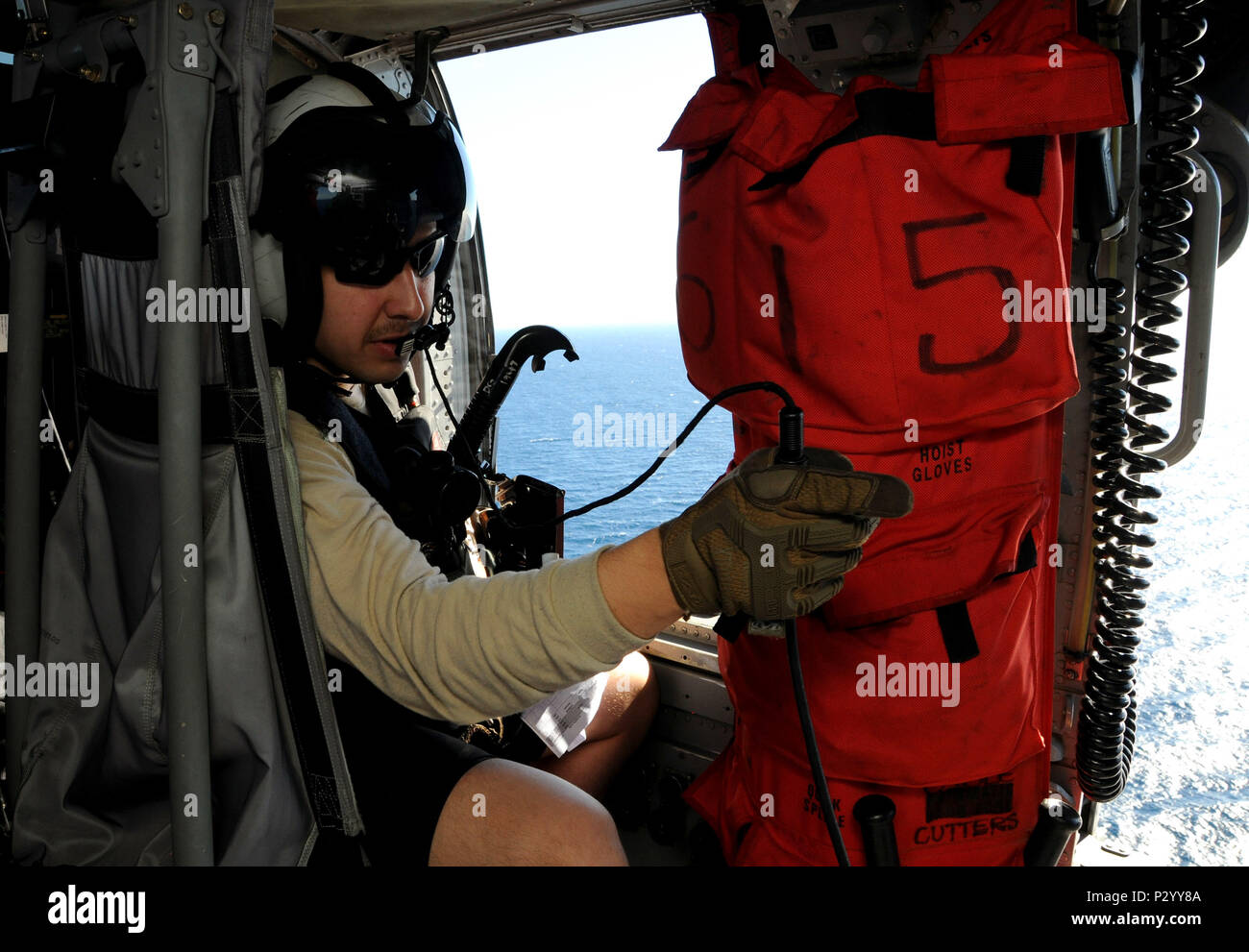 160812-N-XI307-498 ATLANTIC OCEAN (Aug. 12, 2016) Naval Air Crewman (Helicopter) 3rd Class Dalton Gonzales prepares for search and rescue (SAR) training aboard an MH-60S helicopter attached to the 'Tridents' of Helicopter Sea Combat Squadron (HSC) 9. GHWB is underway conducting training and completing qualifications in preparation for a 2017 deployment. (U.S. Navy photo by Mass Communication Specialist 2nd Class Ryan Seelbach/Released) Stock Photo