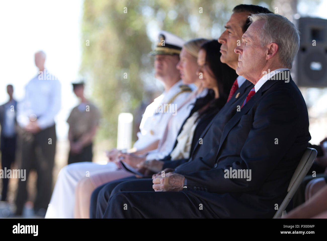 U.S. Secretary of the Navy Mr. Ray E. Mabus and Congressman Darrell Issa (R-CA) listen to Lt. Gen Lewis Craparotta, Commanding General, I Marine Expeditionary Force, make remarks at the ship naming ceremony for the USS John Basilone (DDG-122) on Camp Pendleton, Calif., August 16, 2016. (U.S. Marine Corps photo by Cpl. Tyler S. Dietrich) Stock Photo