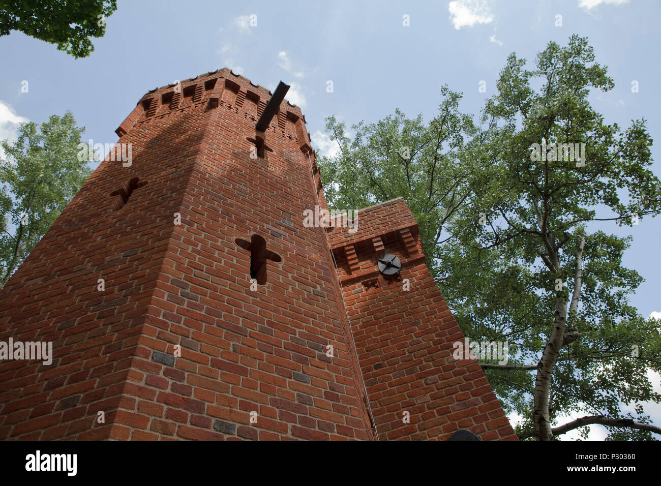 A tower with cross on a wall with sky in backround Stock Photo
