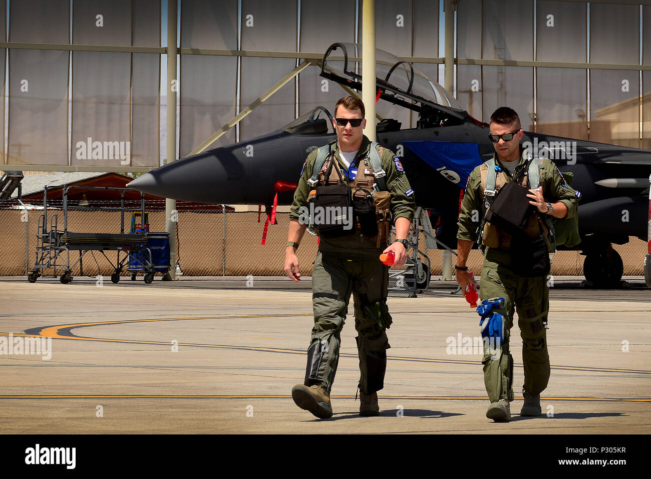 U.S. Air Force 1st Lieutenant Drew Lyons, 492nd Fighter Squadron, F-15E Strike Eagle pilot, and 1st Lieutenant J. Paul Reasner, 492nd FS, F-15E Strike Eagle weapon systems officer, step to their aircraft for a sortie in support of exercise Red Flag 16-4 at Nellis Air Force Base, Nev. Aug 17. Red Flag is the U.S. Air Force’s premier air-to-air combat training exercise and one of a series of advanced training programs that is administered by the U.S. Air Force Warfare Center and executed through the 414th Combat Training Squadron. (U.S. Air Force photo/ Tech. Sgt. Matthew Plew) Stock Photo