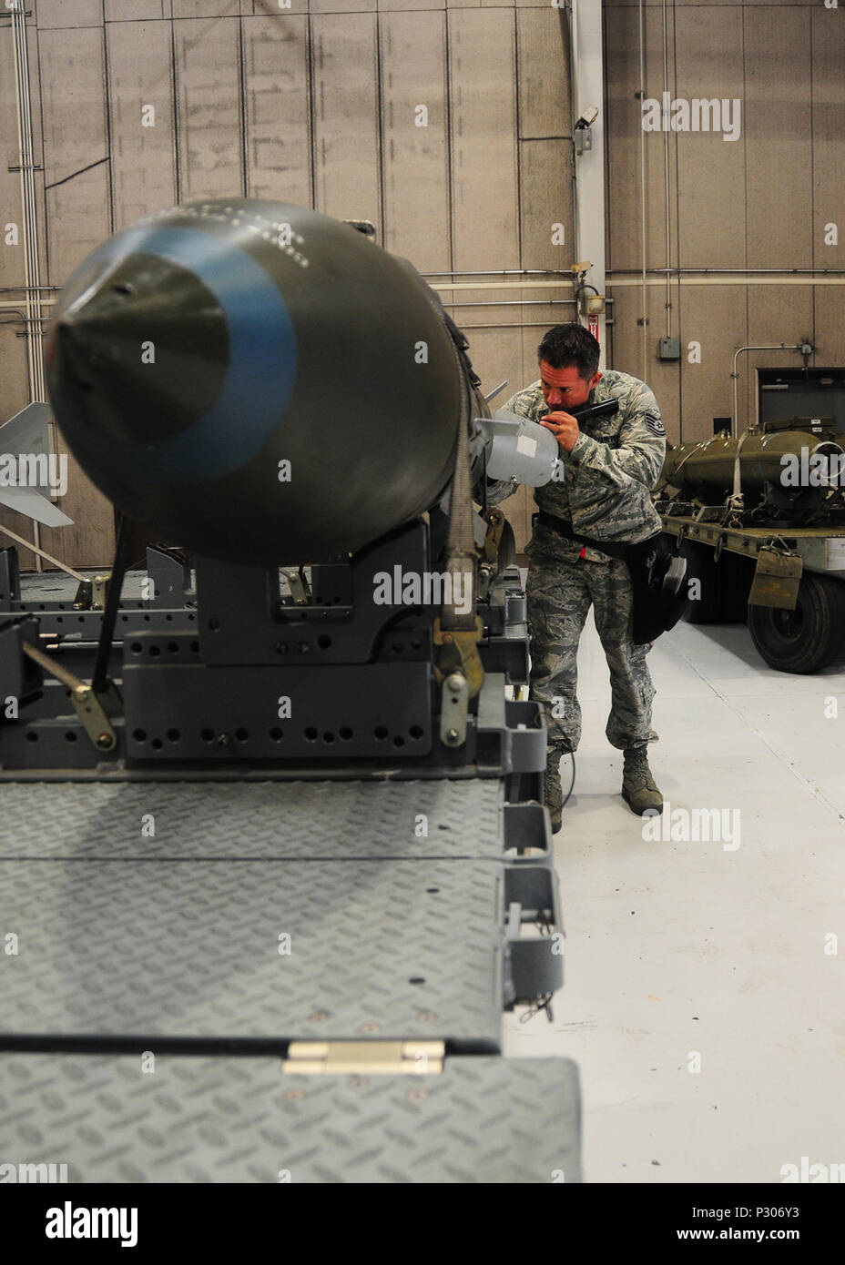 Tech. Sgt. Ricardo Zuniga, 131st Aircraft Maintenance Squadron weapons load  team chief, inspects a V3 Joint Direct Attack Munition before a practice  load on the weapons load trainer at Whiteman Air Force