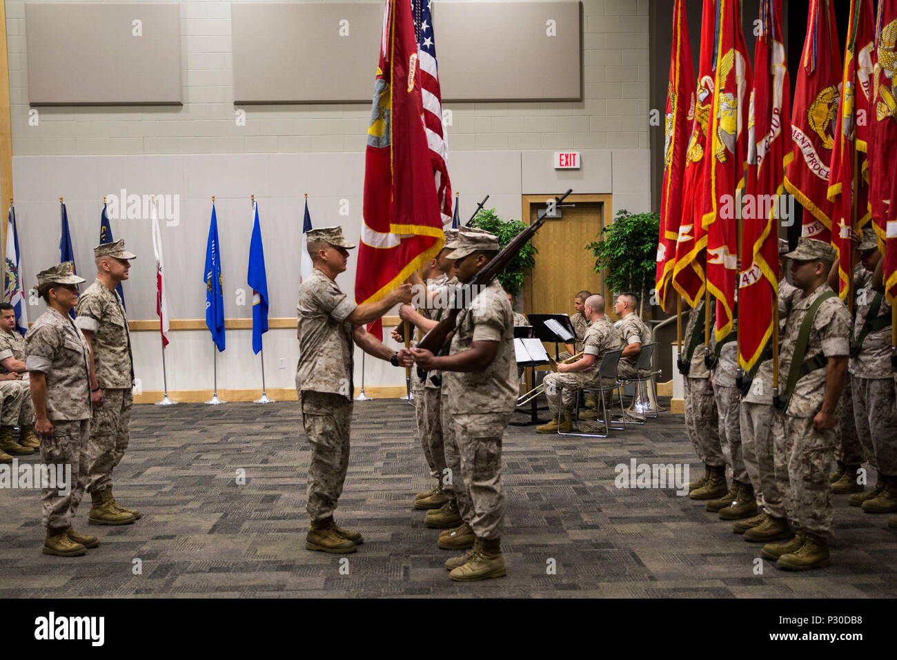 Sgt. Maj. William J. Grigsby (center), Sergeant Major of Force Headquarters Group, Marine Forces Reserve, takes the colors from the FHG color guard during the change of command ceremony at the Federal City Auditorium, New Orleans, Aug. 13, 2016. The passing of the colors symbolizes the transition from one commander to the other. (U.S. Marine Corps photo by Lance Cpl. Melissa Martens/ Released) Stock Photo