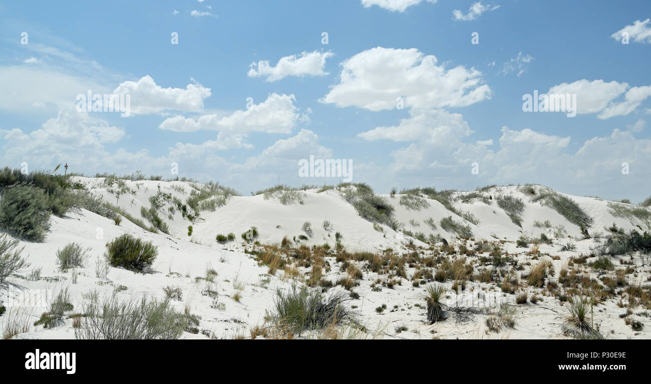 White gypsum sand dunes in southern New Mexico with clouds and a blue sky Stock Photo