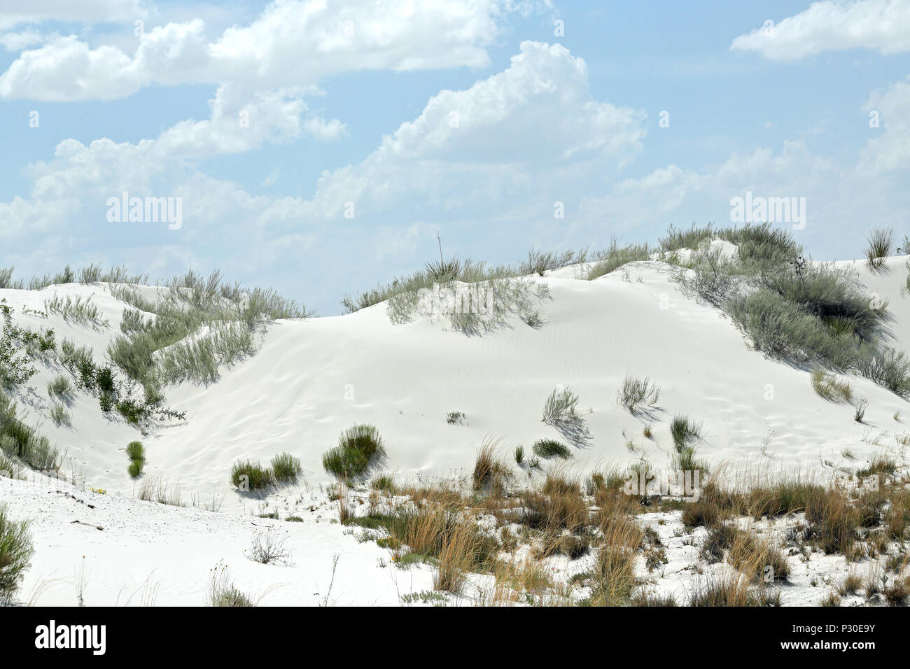 White gypsum sand dunes in southern New Mexico with clouds and a blue sky Stock Photo