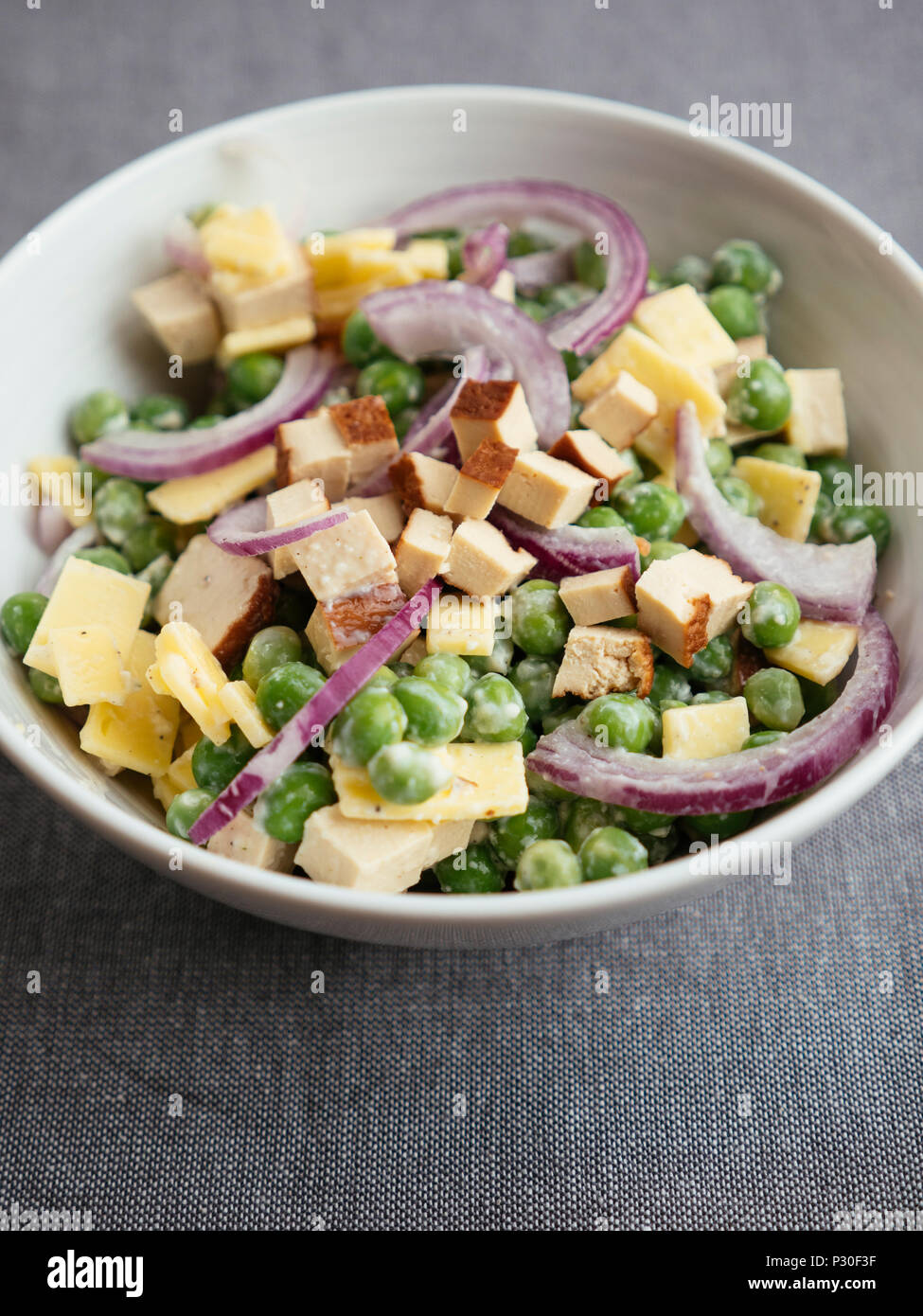 Vegan pea salad with tofu and vegan cheese Stock Photo