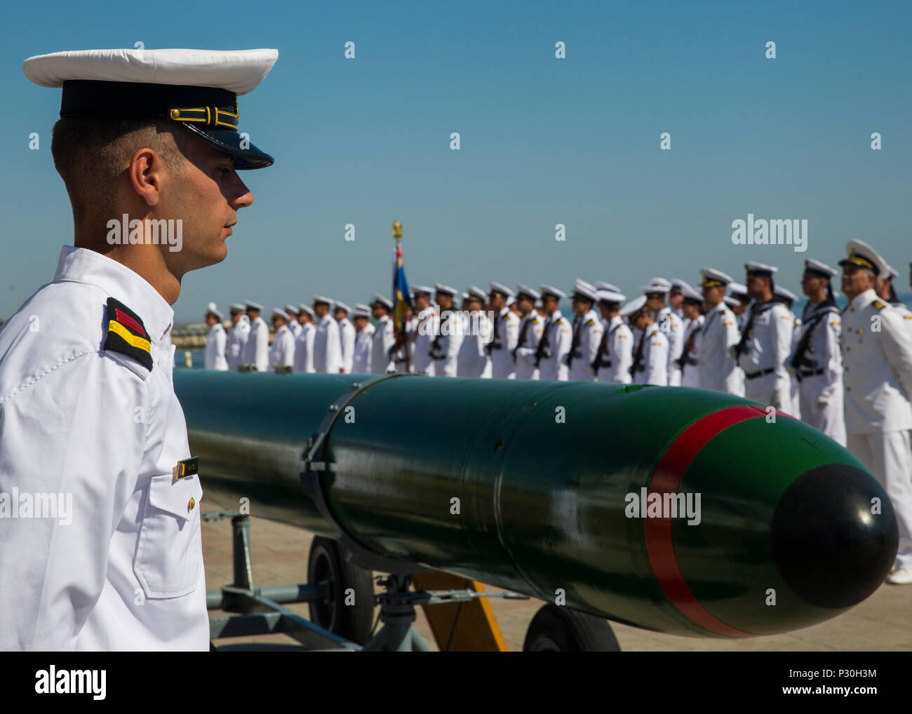 A Romanian sailor stands in front of his platoon during the opening ceremony of the 114th annual Navy Day celebration at the Port of Constanţa, Romania, Aug. 15, 2016. U.S. Sailors and Marines supporting the Black Sea Rotational Force 16.2 helped pay tribute to the prestigious history of the Romanian navy and highlighted the military’s movement toward new developments and modernizations. Black Sea Rotational Force is an annual multilateral security cooperation activity between the U.S. Marine Corps and partner nations in the Black Sea, Balkan and Caucasus regions designed to enhance participan Stock Photo